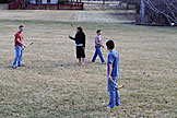 Abe, Erica, April, and Kyle play croquet.