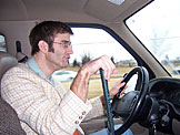 Dan thinks he's changing gears, but it's just a golf club.
