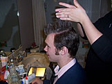 Mark takes a break from helping in the kitchen to get his hair done.