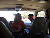 Kristi holds Bert while Kyle grins with pink earmuffs.