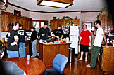 Everyone standing around waiting for breakfast.