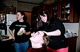 Ruthie double checks the instructions as Erica dyes Michael's hair for the play.