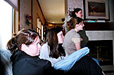 The ladies busy themselves by watching "Pride and Prejudice."