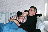 April and Dennis snuggle.  April worries about leaving all of those guys alone in her kitchen.