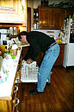 Dennis starts the unending cycle of dishes for the evening.