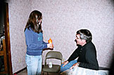 Kirsten presents Dennis with a sippy-cup.