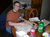 Abe cuts heart shapes in the dough.