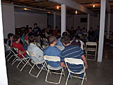 Almost all of the chairs are filled, and the air is filled with praise to God.
