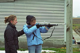 Kristi guides the new shooter, Blessing Longcore.  If you look closely, the gun is chambering a round.