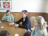 Natalie Stieglitz, Todd Stoller, Alicia Bowie, and Talitha Fischer play cards.